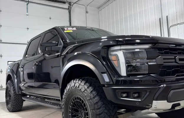 Black lifted Ford Super Duty truck with a deep glossy ceramic-coated finish