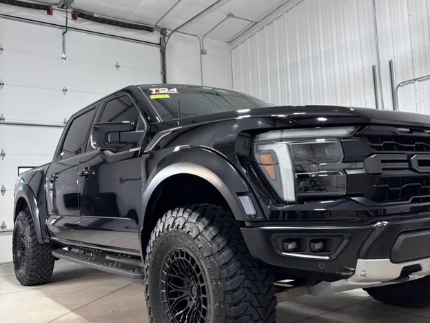 Black lifted Ford Super Duty truck with a deep glossy ceramic-coated finish