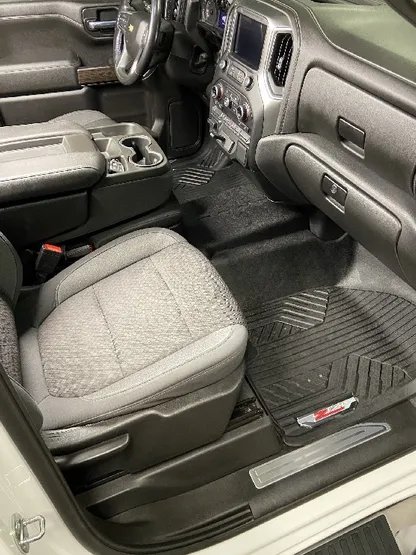 Truck interior with clean gray cloth seats and floor mats after detailing