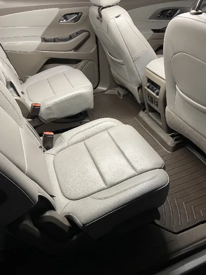 Three-row SUV with clean cream leather captain's chairs after detailing