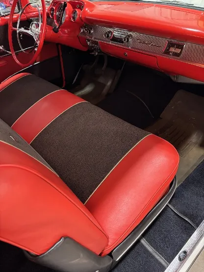 Vintage car interior with clean red and black bench seat after detailing