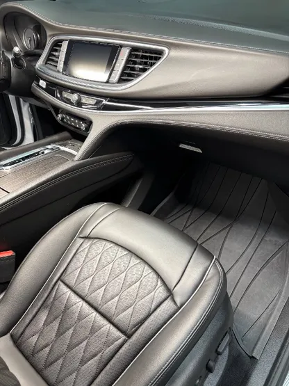 Luxury sedan interior with clean quilted black leather seats after detailing