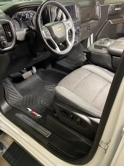 Truck interior with clean light gray seats and dash after detailing