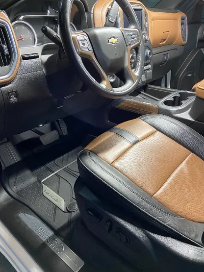 Truck interior with clean two-tone leather bucket seats after detailing