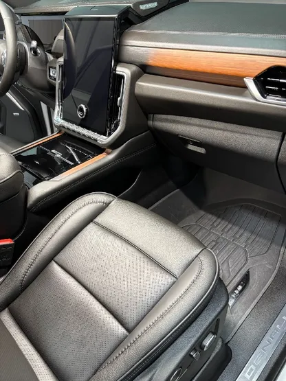 SUV interior with clean leather seats and wood trim after detailing