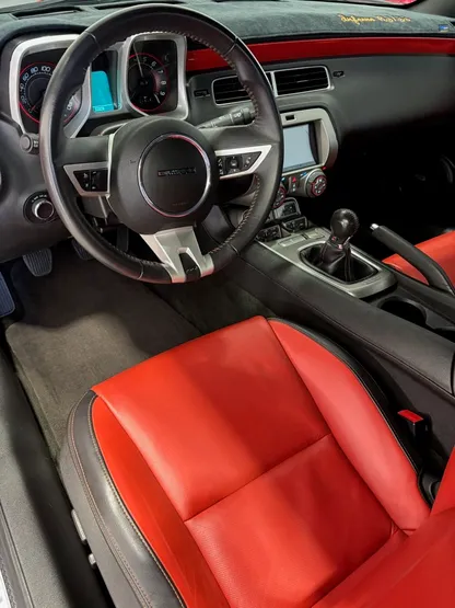 Classic Camaro interior with red leather seats after detailing