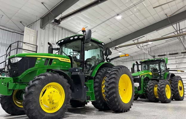 Two green John Deere tractors after detailing, parked in the Hermsmeyer Detailing shop
